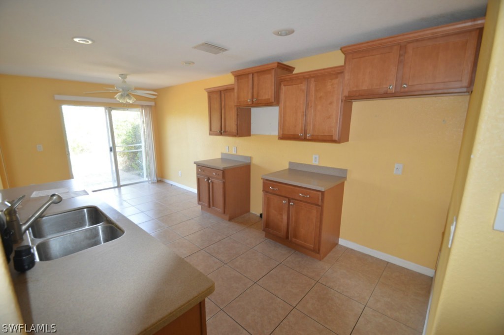 11706 Tempest Harbor Loop Venice, FL 34292 - Photo 6 of 20 a kitchen with stainless steel appliances a sink and a refrigerator