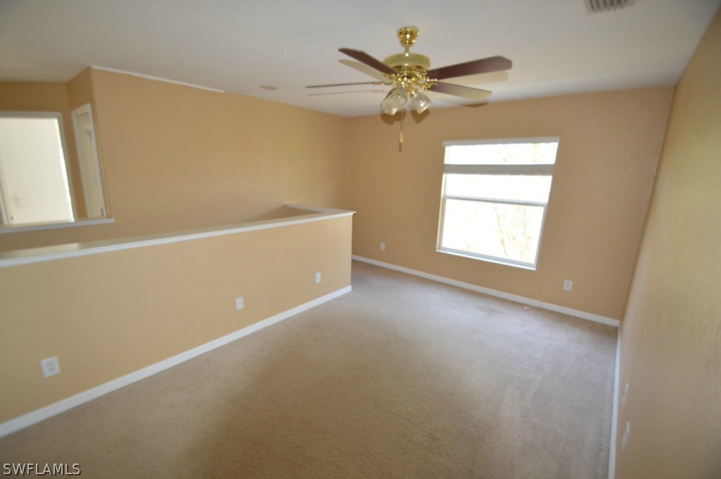 11706 Tempest Harbor Loop Venice, FL 34292 - Photo 9 of 20 an empty room with windows and fan