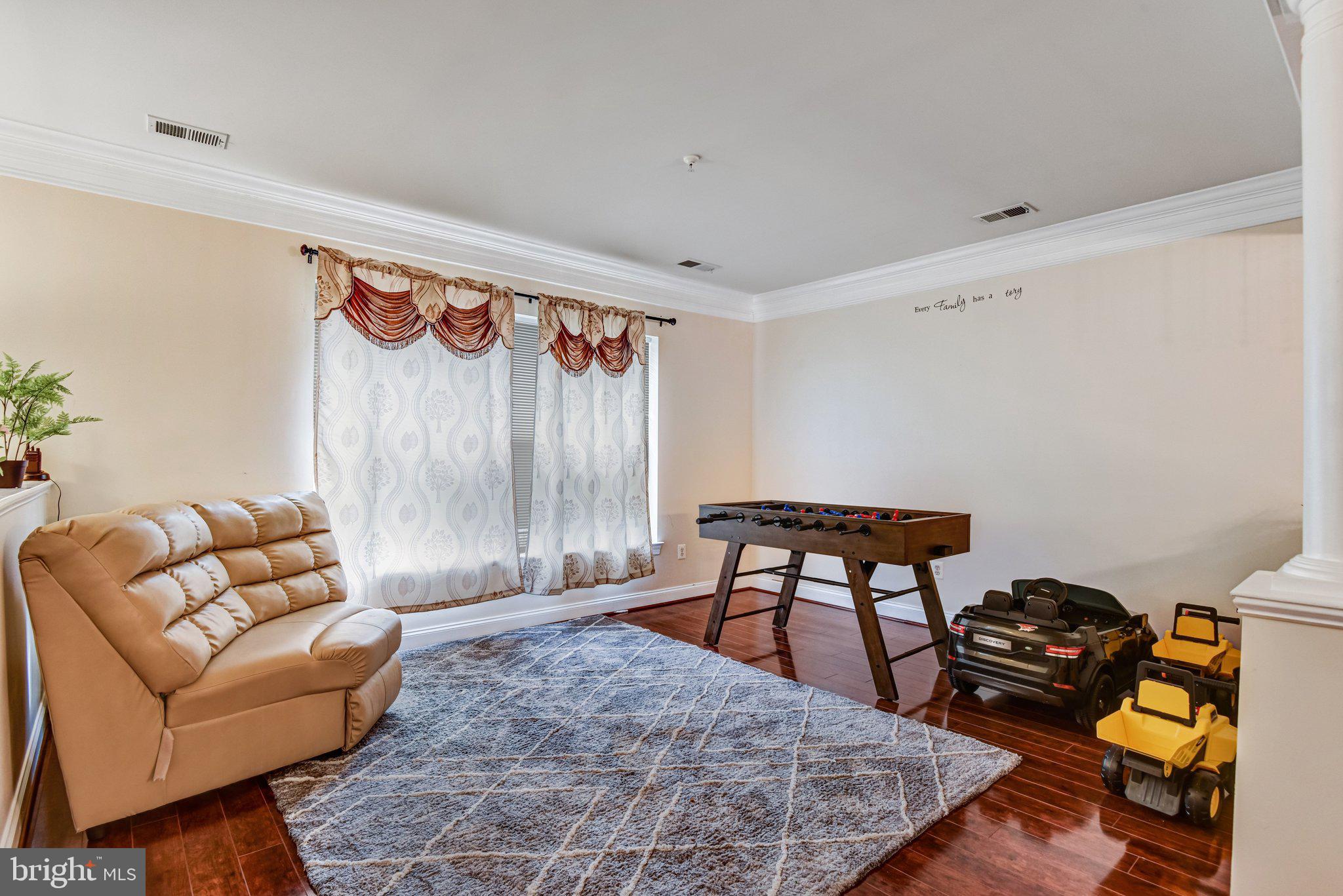 4112 Potomac Highlands Circle Triangle, VA 22172 - Photo 16 of 41 a living room with furniture and a wooden floor