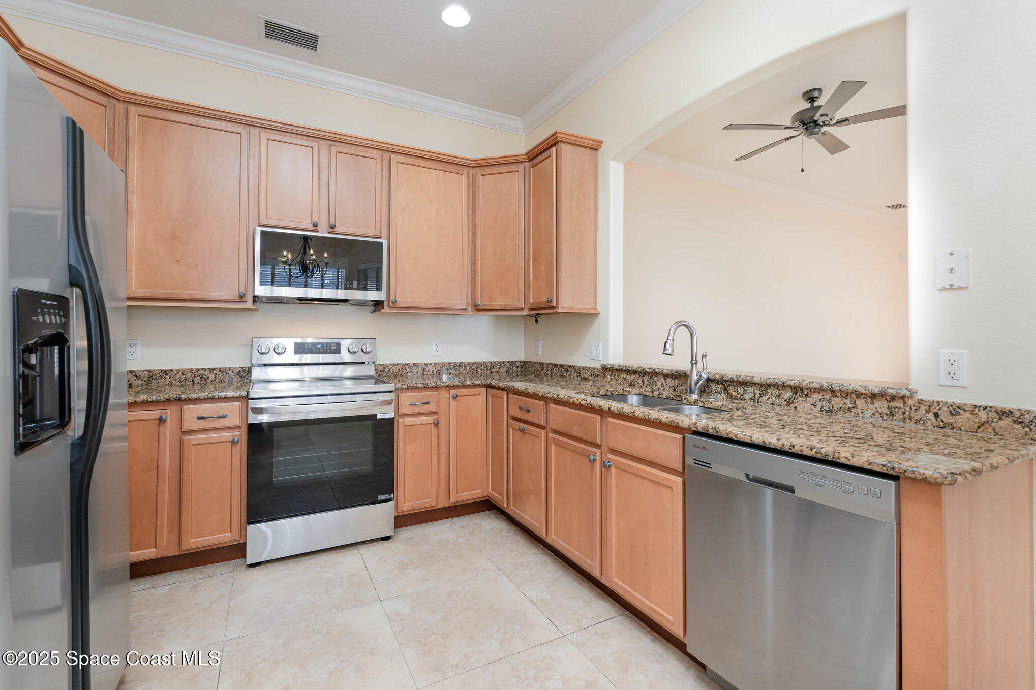 4150 Alamanda Key Drive Melbourne, FL 32901 - Photo 11 of 65 a kitchen with stainless steel appliances granite countertop a stove a sink and a microwave