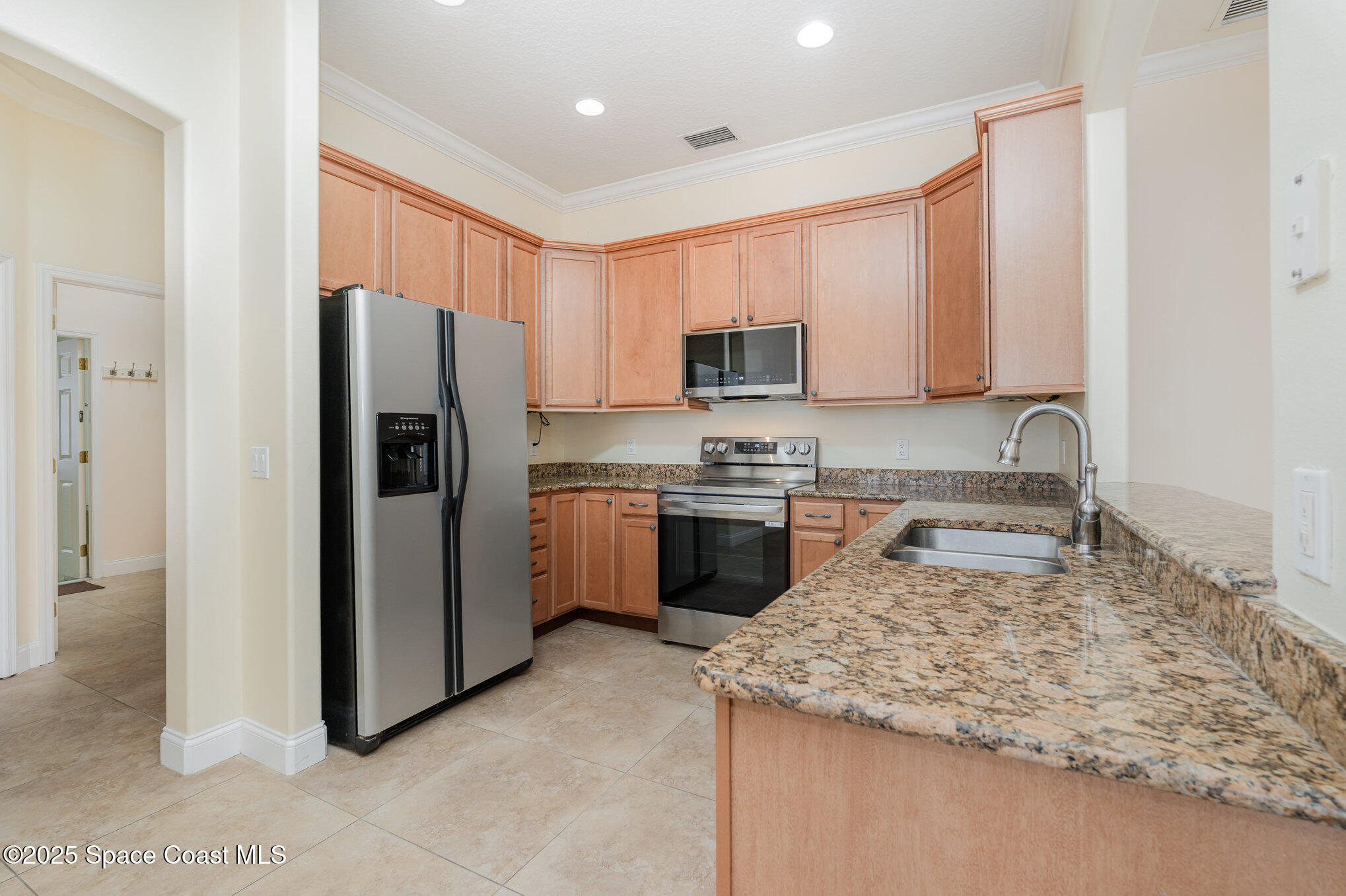 4150 Alamanda Key Drive Melbourne, FL 32901 - Photo 12 of 65 a kitchen with a refrigerator sink and cabinets