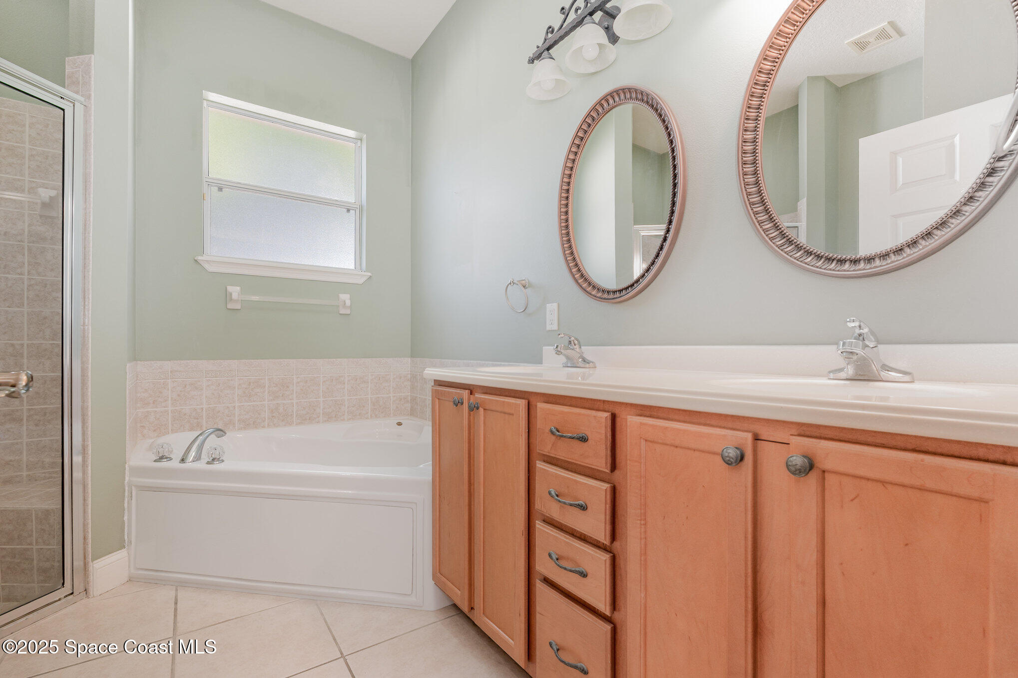 4150 Alamanda Key Drive Melbourne, FL 32901 - Photo 20 of 65 a bathroom with a sink a toilet and a mirror