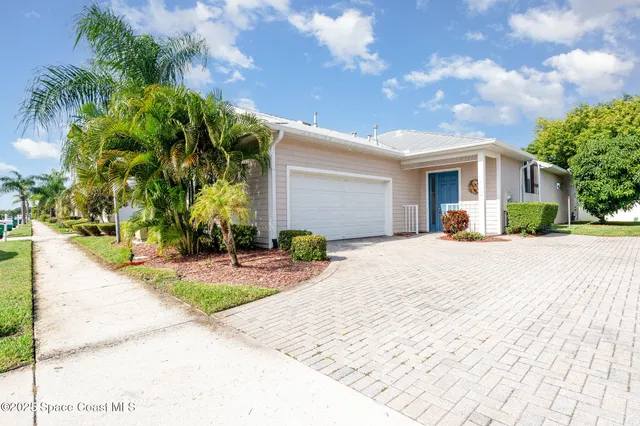 a front view of a house with a yard and a garage