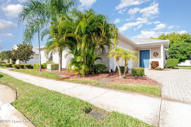 a view of a hallway with wooden floor and a bathroom