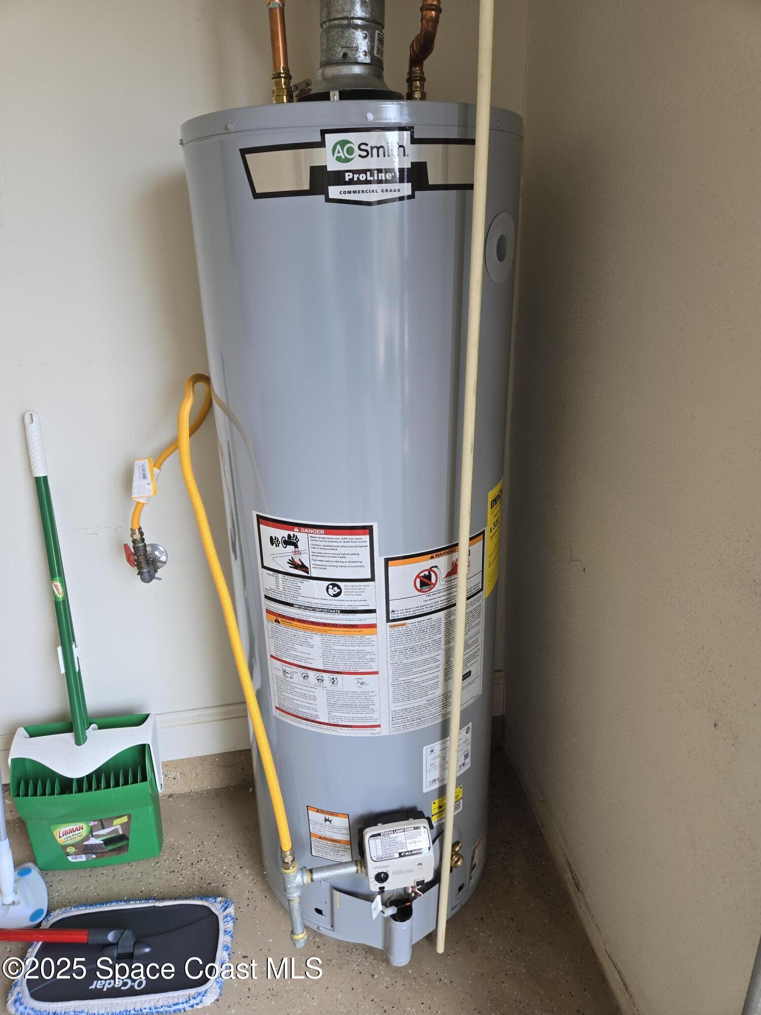 4150 Alamanda Key Drive Melbourne, FL 32901 - Photo 31 of 65 a room with water heater and wooden floor