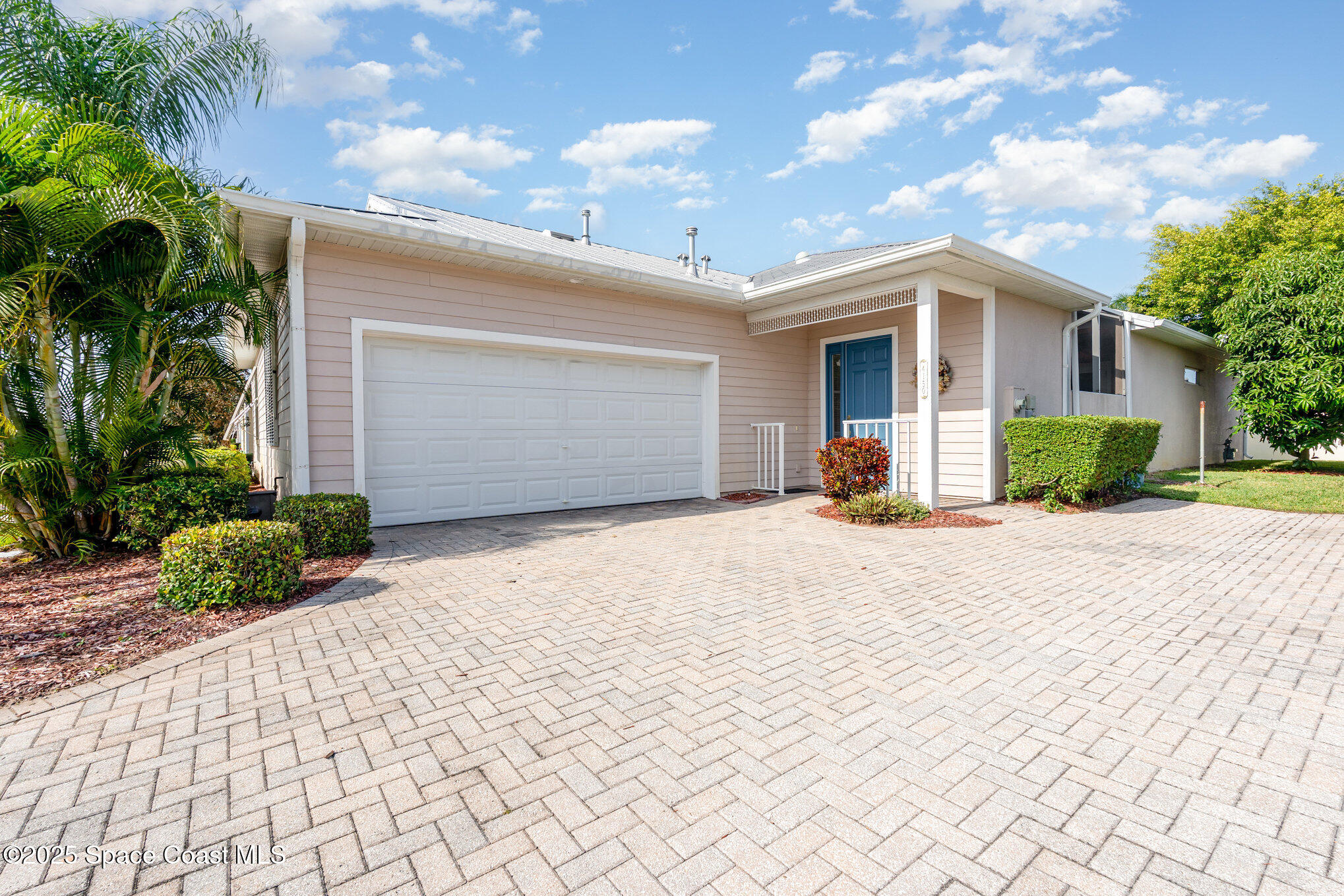 4150 Alamanda Key Drive Melbourne, FL 32901 - Photo 4 of 65 a front view of a house with a yard and a garage