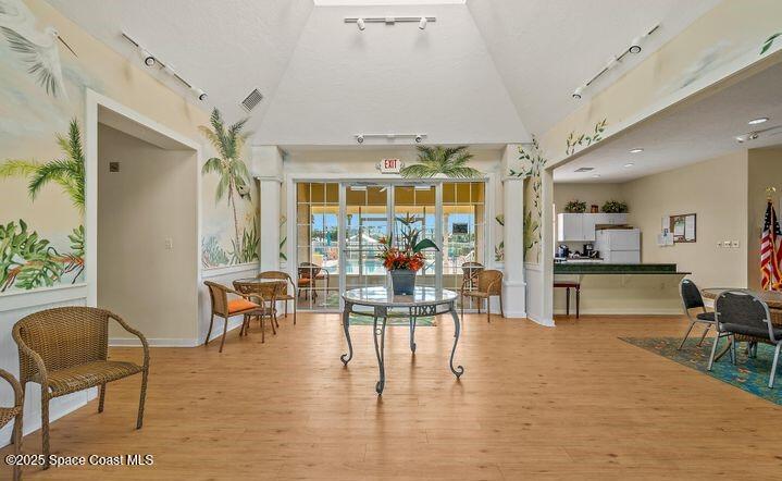 4150 Alamanda Key Drive Melbourne, FL 32901 - Photo 42 of 65 a dining room with furniture a chandelier and wooden floor