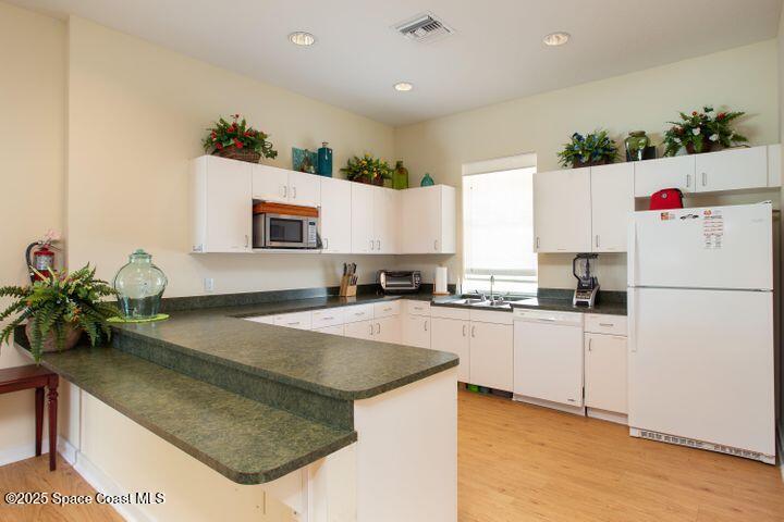 4150 Alamanda Key Drive Melbourne, FL 32901 - Photo 44 of 65 a kitchen with granite countertop a sink and white appliances