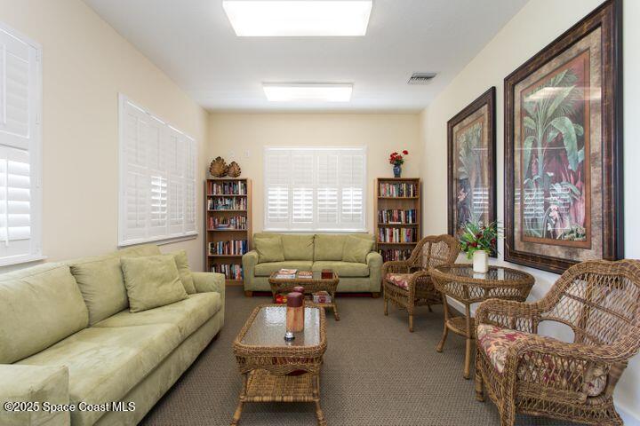 4150 Alamanda Key Drive Melbourne, FL 32901 - Photo 45 of 65 a living room with furniture and large windows