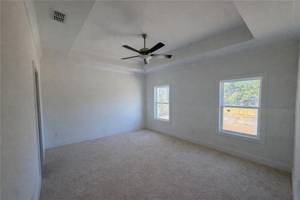 287 Bell Grove Lane Suwanee, GA 30024 - Photo 12 of 29 an empty room with a window and a fan