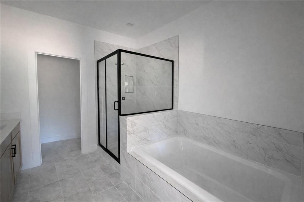 287 Bell Grove Lane Suwanee, GA 30024 - Photo 14 of 29 a bathroom with a bathtub and a shower