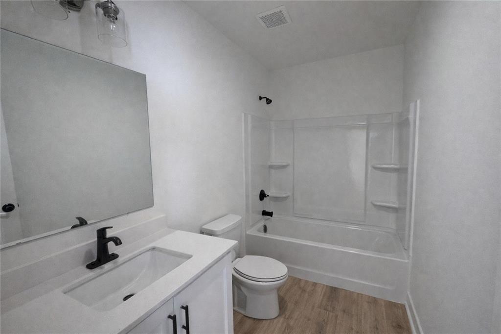 287 Bell Grove Lane Suwanee, GA 30024 - Photo 17 of 29 a bathroom with a sink a toilet and shower