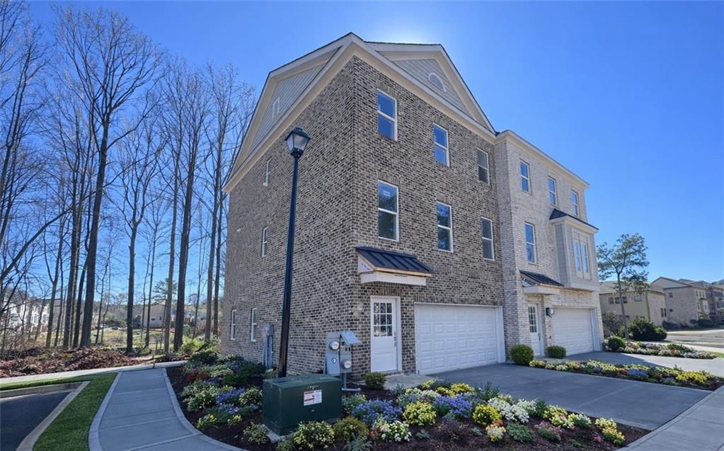287 Bell Grove Lane Suwanee, GA 30024 - Photo 2 of 29 a front view of a building with garden