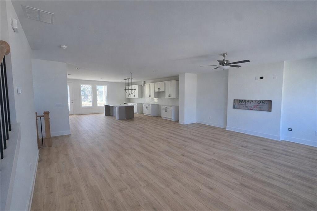 287 Bell Grove Lane Suwanee, GA 30024 - Photo 4 of 29 a view of empty room with wooden floor