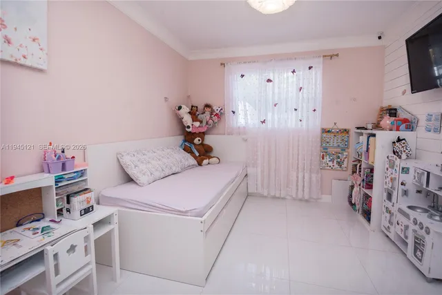 a bed room with a bed and a chair