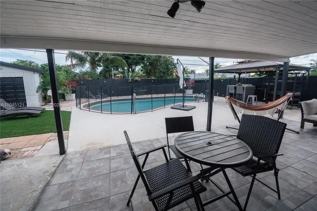 a swimming pool with outdoor seating and yard