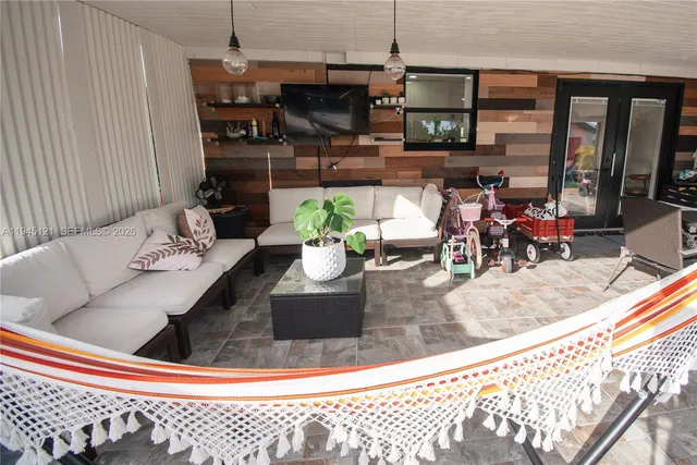 a living room with furniture and a flat screen tv