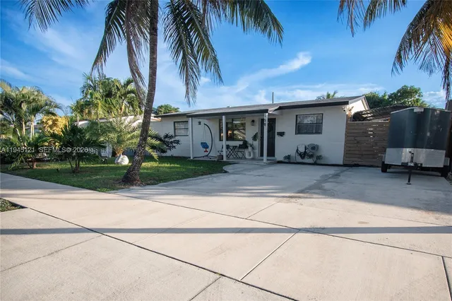 a view of a porch with furniture and garden