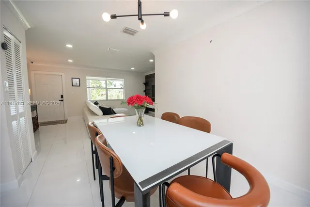 a view of a dining room with furniture and chandelier