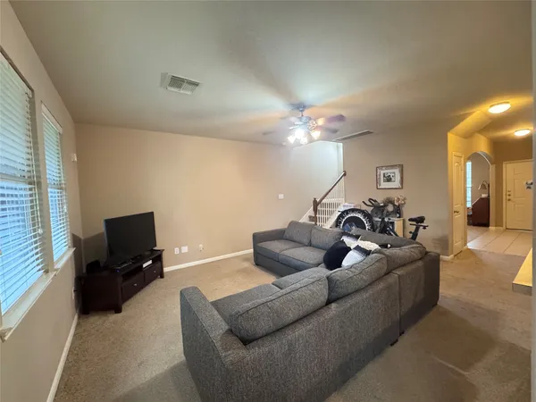 a living room with furniture and a flat screen tv