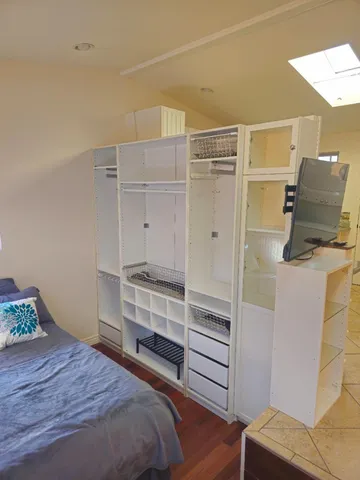 a bedroom with a bed and chair