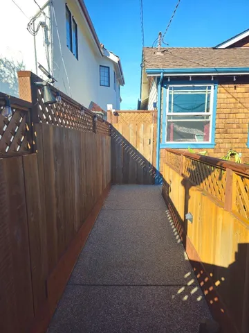 a view of a house with a wooden fence
