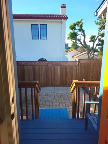a view of a patio with table and chairs with wooden floor and plants
