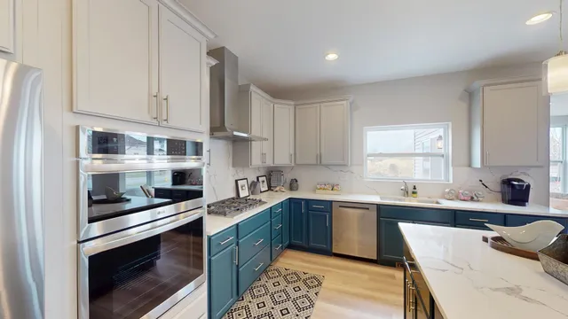 a large kitchen with a sink a counter space and appliances