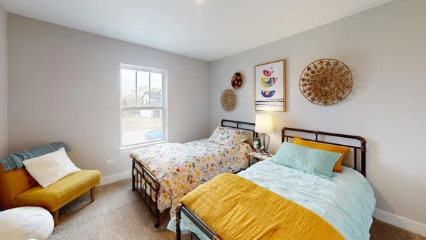 a bedroom with a bed and a painting on the wall