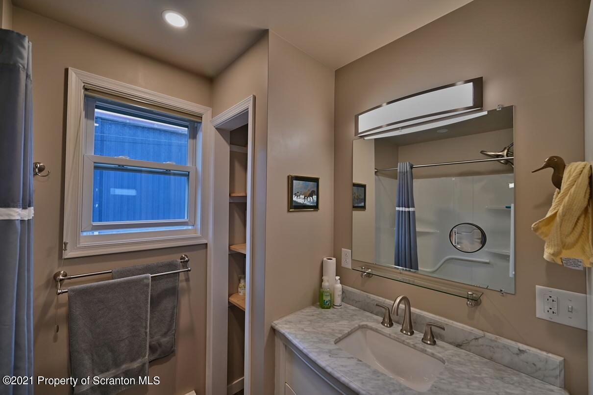 303 Main Street Nicholson, PA 18446 - Photo 20 of 98 a bathroom with a granite countertop sink vanity and mirror
