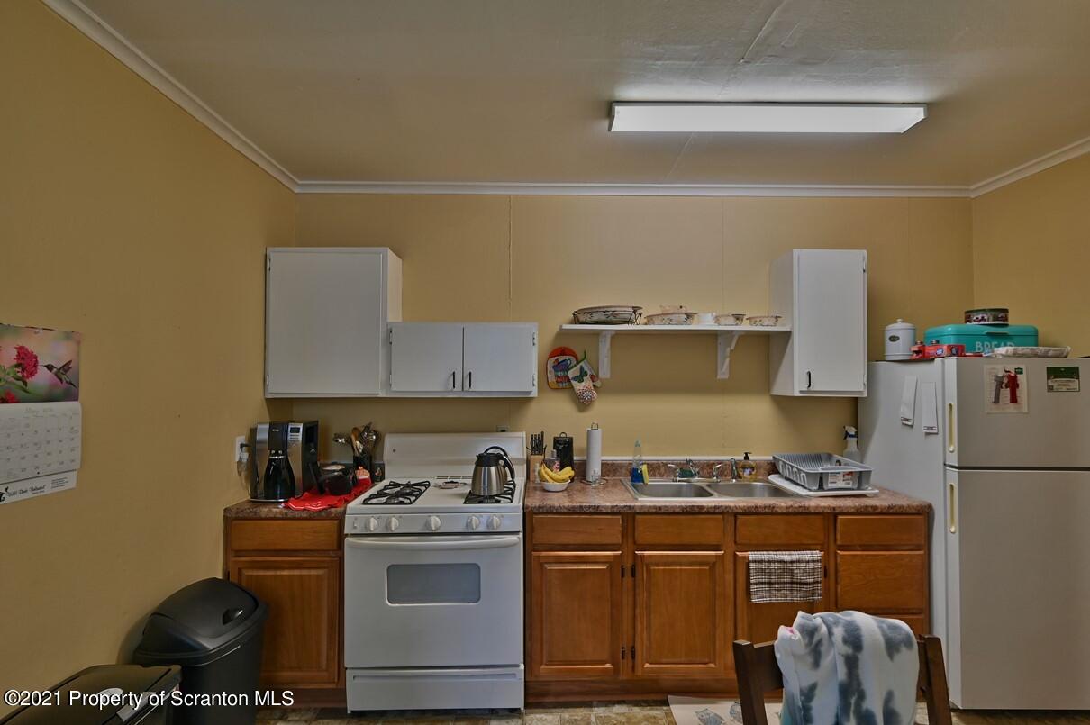 303 Main Street Nicholson, PA 18446 - Photo 42 of 98 a kitchen with a refrigerator and a stove