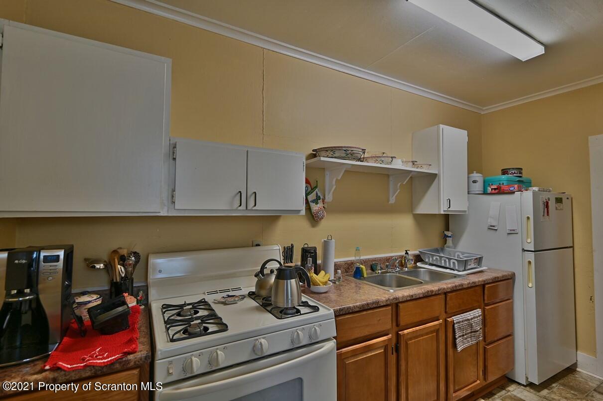 303 Main Street Nicholson, PA 18446 - Photo 43 of 98 a kitchen with a stove and a refrigerator