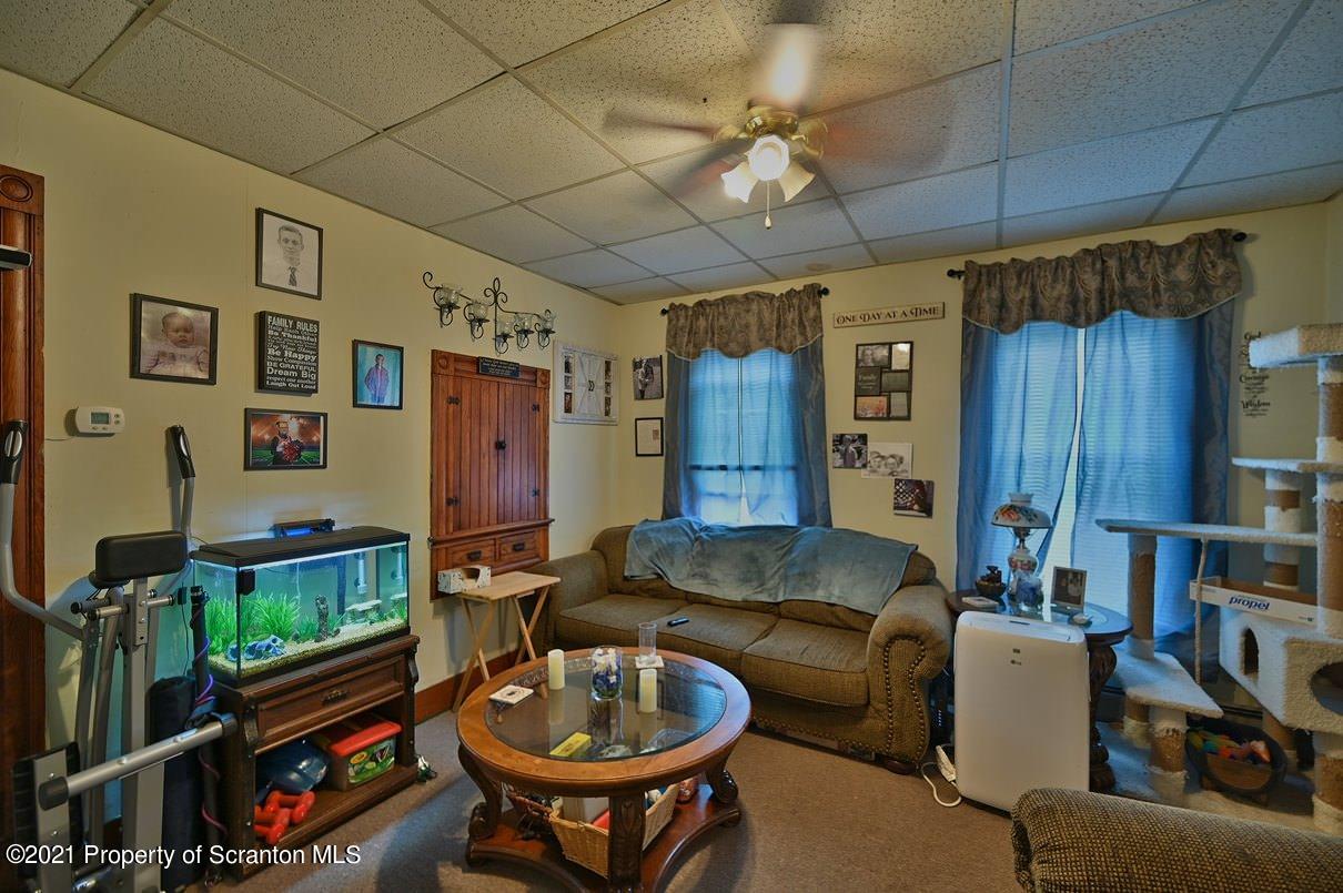 303 Main Street Nicholson, PA 18446 - Photo 57 of 98 a living room with furniture a flat screen tv and a sink