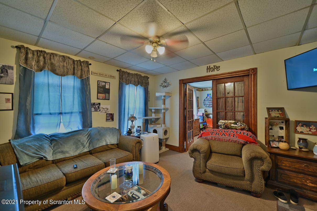 303 Main Street Nicholson, PA 18446 - Photo 59 of 98 a living room with furniture and a chandelier