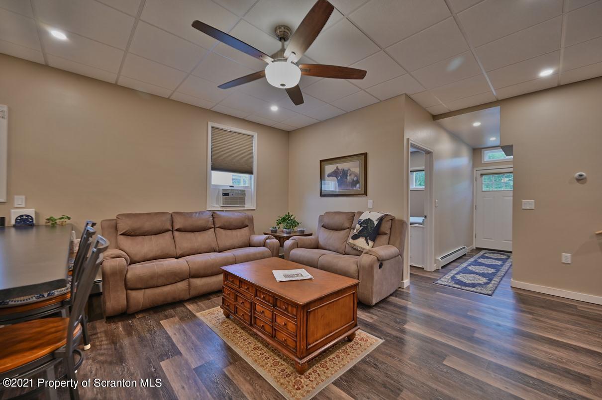 303 Main Street Nicholson, PA 18446 - Photo 6 of 98 a living room with furniture a ceiling fan and a rug