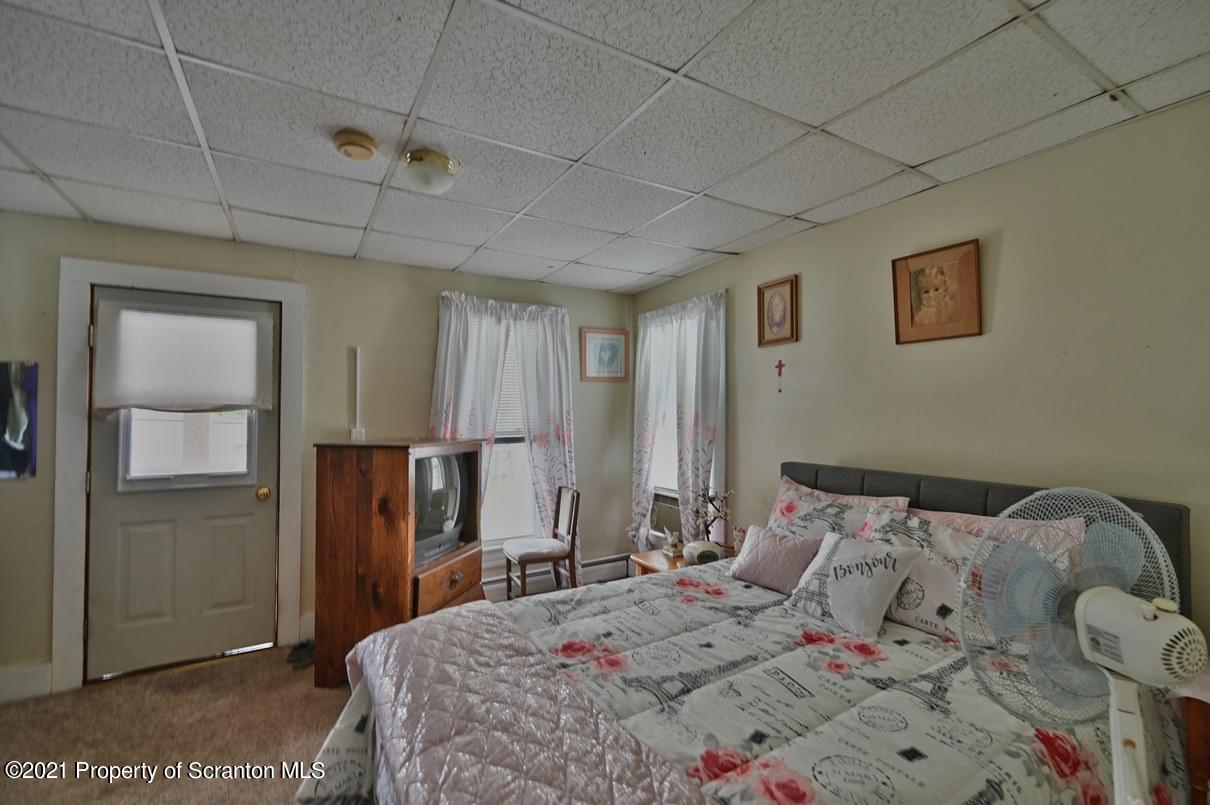 303 Main Street Nicholson, PA 18446 - Photo 79 of 98 a bedroom with a bed and a refrigerator