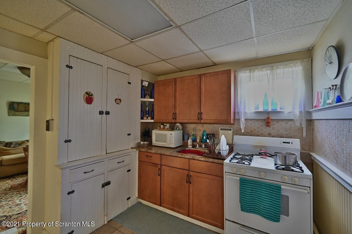 303 Main Street Nicholson, PA 18446 - Photo 89 of 98 a kitchen with stainless steel appliances granite countertop a sink stove and cabinets