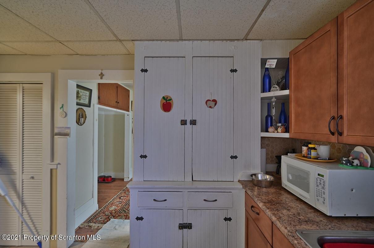 303 Main Street Nicholson, PA 18446 - Photo 90 of 98 a bathroom with a granite countertop shower sink and cabinets