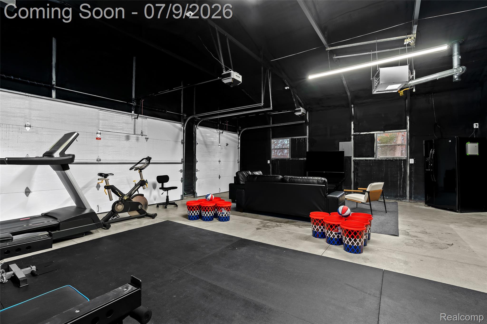 2566 Harrington Road Rochester, MI 48307 - Photo 61 of 64 Fun hangout space in the garage with a thermostat controlled heating unit, refrigerator, TV and games