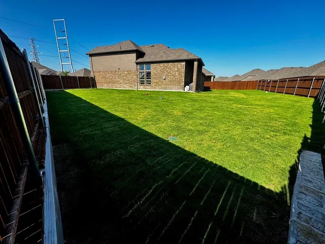 a view of a backyard with large trees