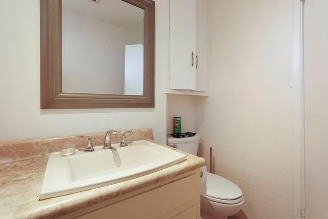 a view of a balcony with wooden chairs and city view