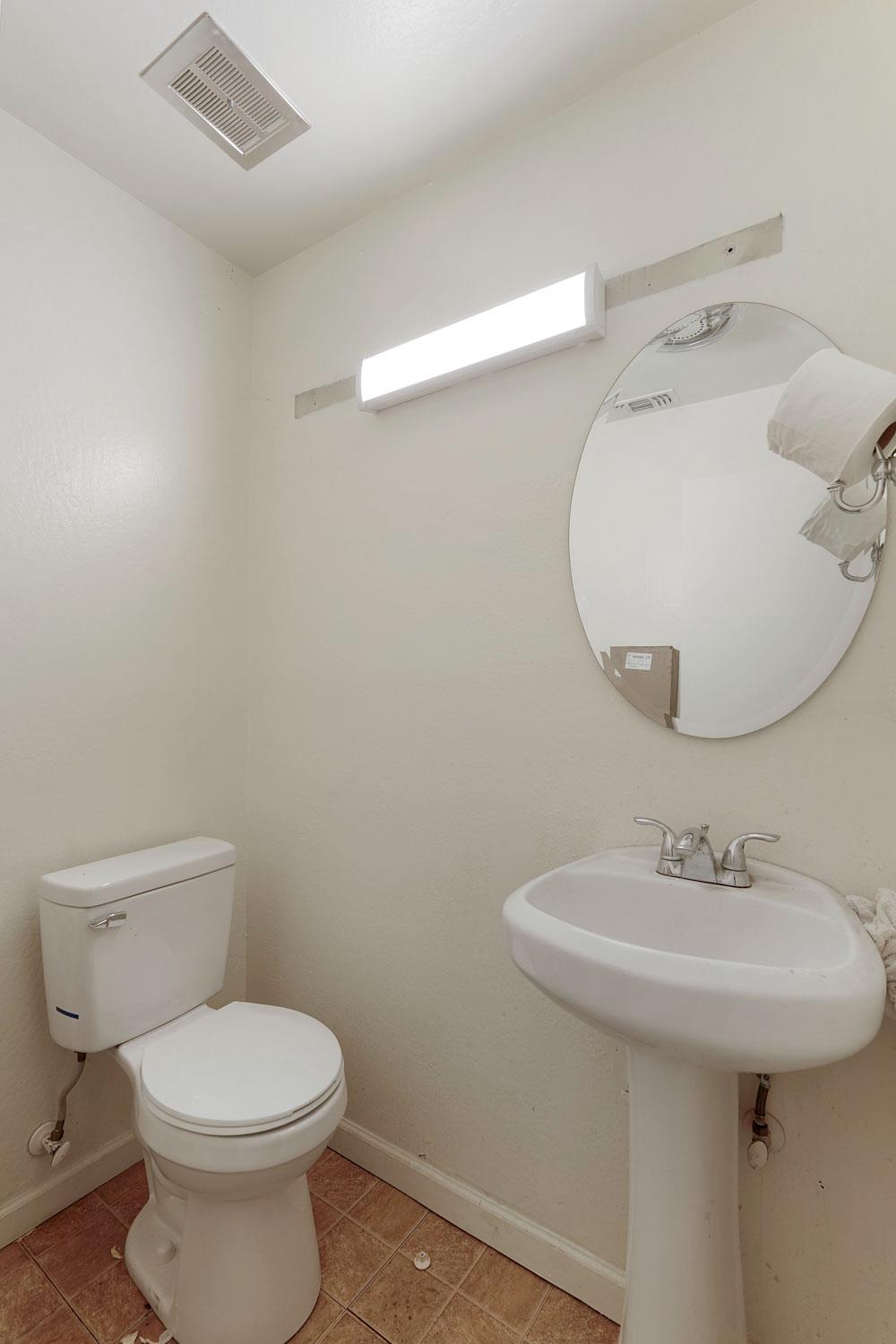 14144 Market Street Walnut Grove, CA 95690 - Photo 33 of 86 a bathroom with a sink a toilet and mirror