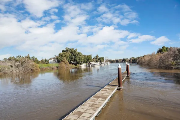 a living room with lots of furniture and a painting on the wall