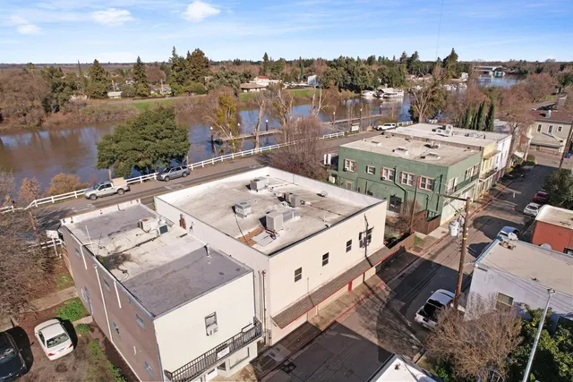 an aerial view of a house with outdoor space and lake view