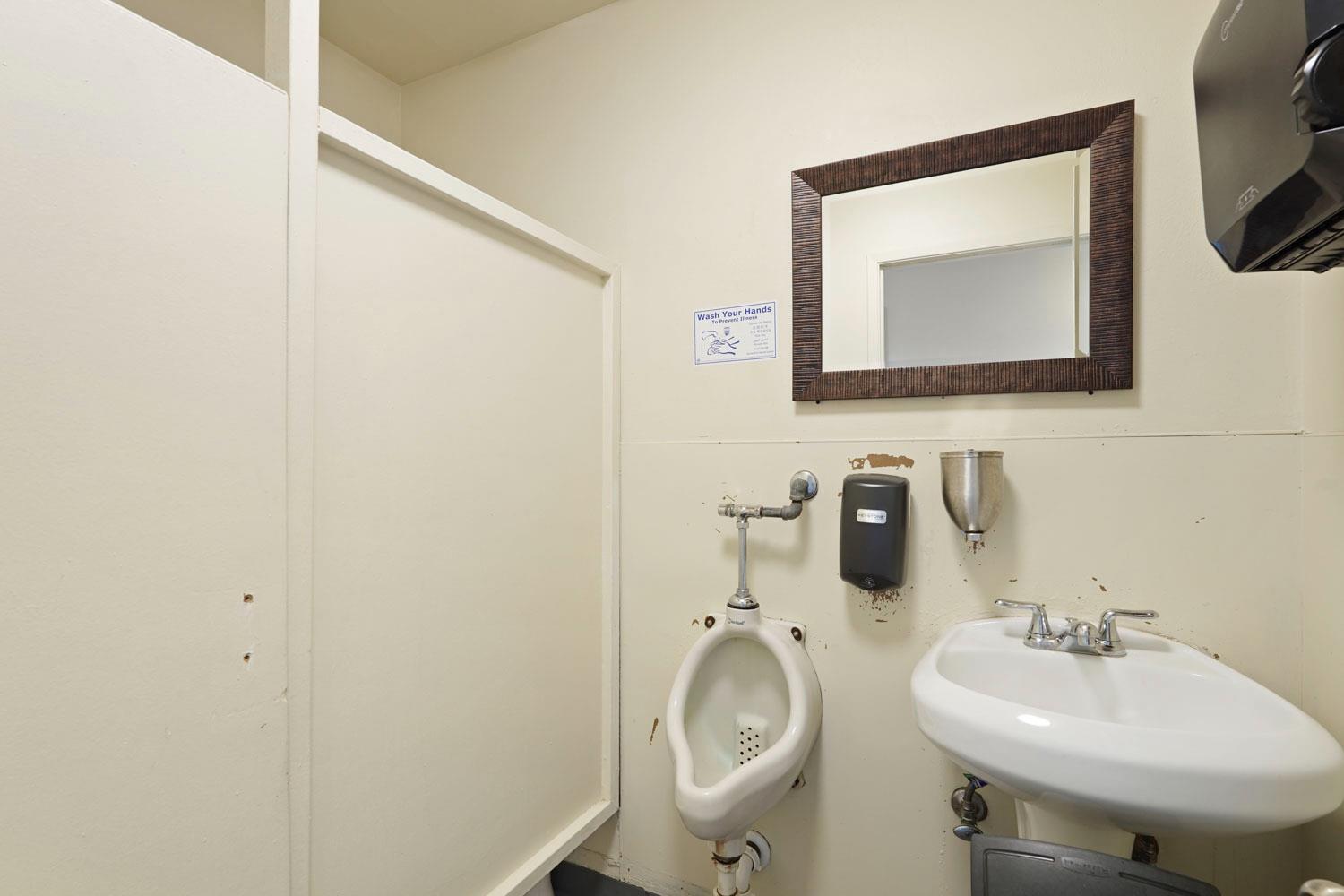 14144 Market Street Walnut Grove, CA 95690 - Photo 65 of 86 a bathroom with a toilet sink and mirror