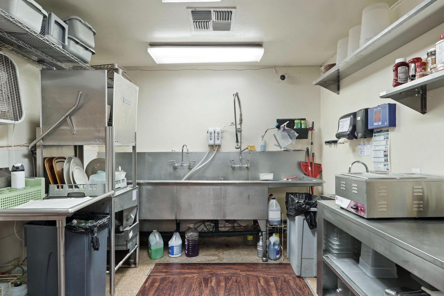14144 Market Street Walnut Grove, CA 95690 - Photo 71 of 86 a kitchen with a sink a stove and chairs