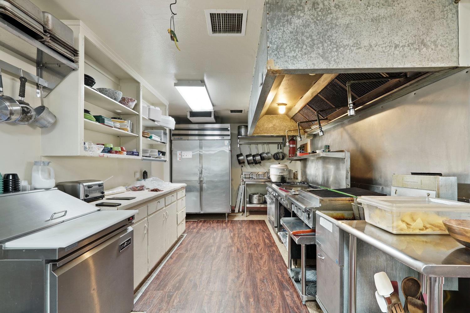 14144 Market Street Walnut Grove, CA 95690 - Photo 74 of 86 a kitchen that has a lot of cabinets in it