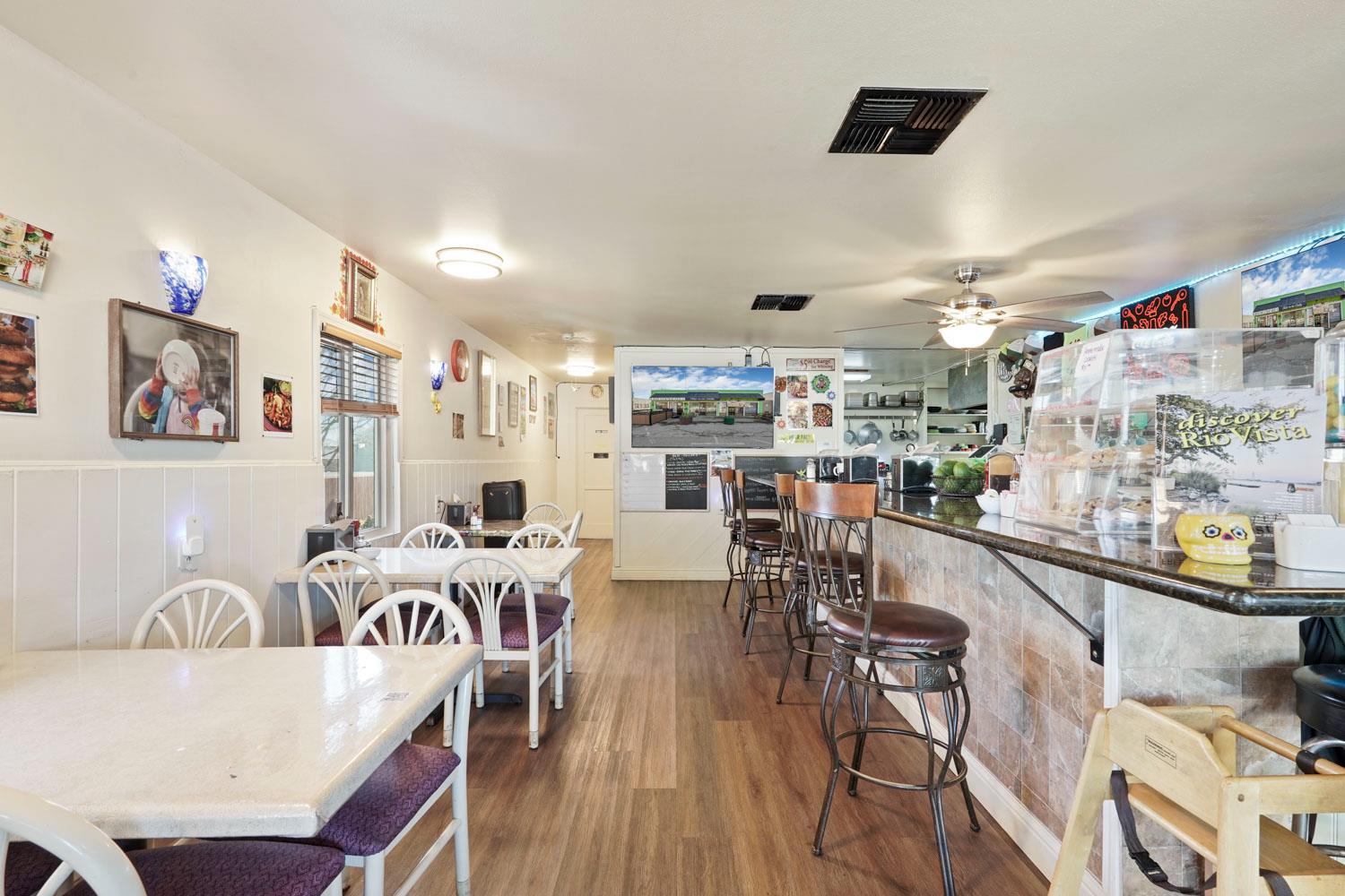 14144 Market Street Walnut Grove, CA 95690 - Photo 79 of 86 a living room with lots of furniture and kitchen view