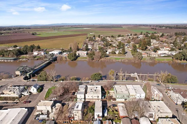 an aerial view of a city with ocean view in back