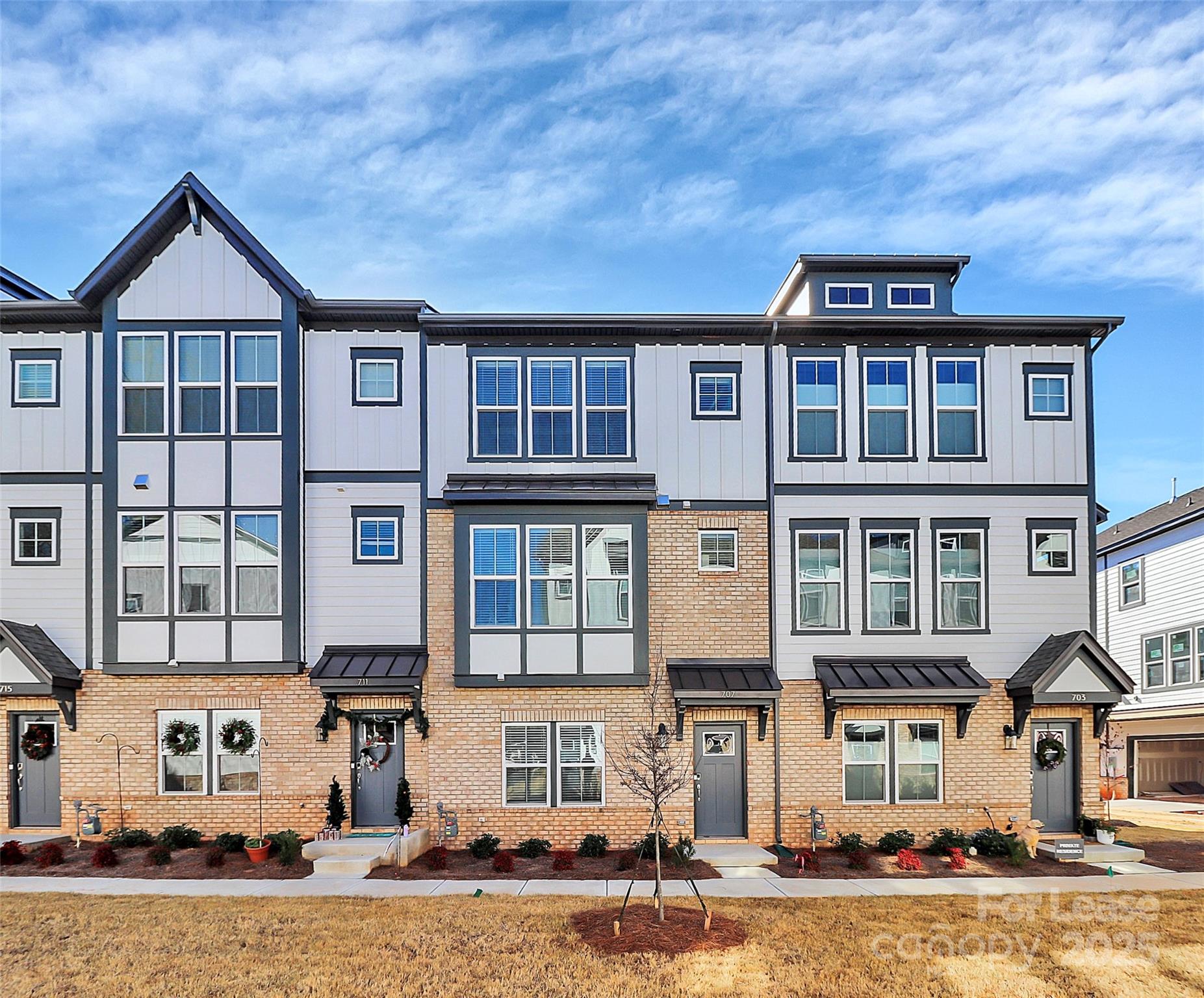 a front view of a residential apartment building with a yard